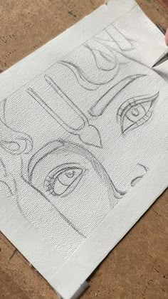 someone is drawing an image on a piece of paper