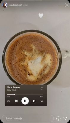 a cup of coffee on top of a table with an mp3 player next to it