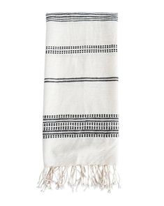 a white and black towel with fringes on it's edge, against a white background