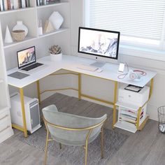 a computer desk with two computers on top of it and a chair next to it