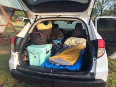 the back end of a white van filled with luggage