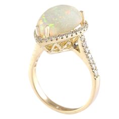 Stamped: 14K Yellow Gold Total Ring Weight: 5.9 Grams Ring Length: N/ARing Width: N/A Gemstone Weight: Total Natural Opal Weight is 4.67 Carat (Measures: 14.80x11.10 mm) Color: Multicolor Diamond Weight: Total Natural Diamond Weight is 0.60 Carat Quantity: 46 Color: F-G, Clarity: VS2-SI1 Face Measures: 18.95x14.10 mm Sku: [703967W] White Rings With Accent Stones For Formal Occasions, Formal White Rings With Accent Stones, Formal Multi-stone Opal Ring With Diamonds, Formal Multi-stone Diamond Opal Ring, White Gemstone Birthstone Ring For Formal Occasion, Formal White Birthstone Ring With Gemstone, Elegant Yellow Gold Opal Ring For Formal Occasions, Formal Opal Ring, Oval Multi-stone Yellow Gold Rings