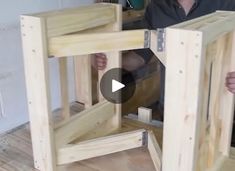 a man is holding up some wooden frames to show how they are made and put together