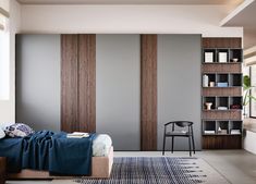 a bed sitting in a bedroom next to a book shelf