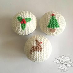 three white buttons with christmas decorations on them