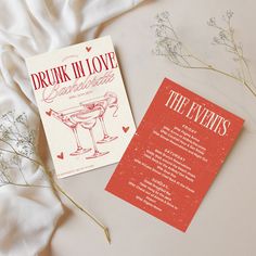 two cards sitting next to each other on top of a bed covered in white sheets