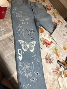 Custom acrylic painted jeans or denim jackets! I can do whatever you have in mind or I can make a design for you based on your likes/interests! The prices will range based on if you want a jacket or pants and how much or little you want painted, (between $50-$250). Jeans With Art On Them, Customized Denim Jeans, Painted Pants Design, Designs To Paint On Jeans, Pants Paint Design, Painting On Denim Jeans, Customized Pants Jeans, Jeans With Drawings On Them, Painting In Clothes