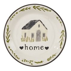 a white plate with a house painted on the front and words home written in black