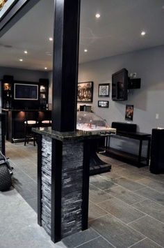 a living room filled with lots of furniture and decor on top of stone flooring