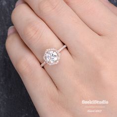 a woman's hand with a diamond ring on her finger and an engagement band