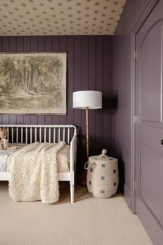 a bedroom with purple walls and white furniture