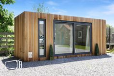 a small wooden building sitting on top of a gravel field