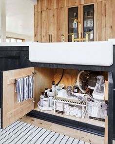 the kitchen cabinet is open to reveal everything in its storage compartment, and it's organized