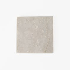 a square marble tile on a white background with no one around it or someone else