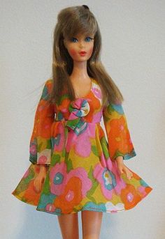 a barbie doll is wearing a colorful dress