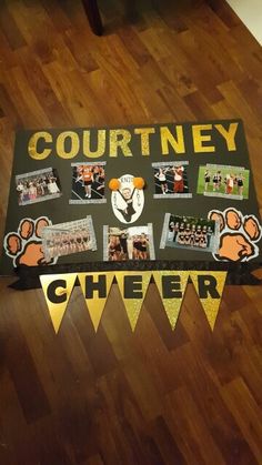 a table topped with pictures and pennants on top of a wooden floor