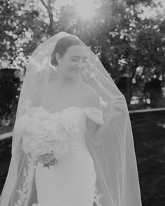 black and white photograph of a bride in her wedding dress with veil over her head