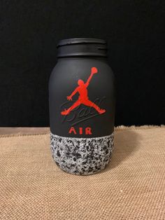 a black and red air canister sitting on top of a burlap surface