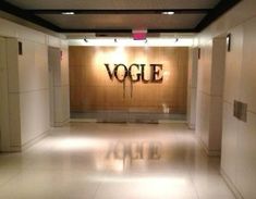 an empty room with the word voge painted on it's wall and two elevators