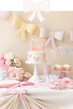 a table topped with lots of cake and cupcakes