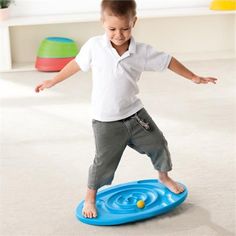 a young boy is playing with a frisbee