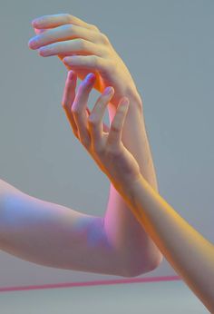 two hands reaching up to touch each other's arm with neon lights in the background