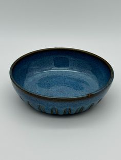 a blue bowl sitting on top of a white table