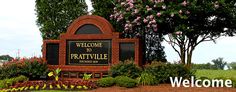 a welcome sign in front of some trees and flowers with the words, welcome to pratville