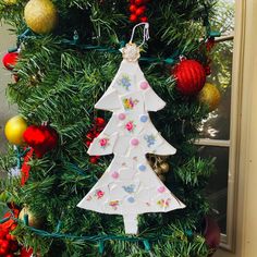 a decorated christmas tree with ornaments hanging from it