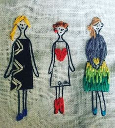 three hand embroidered children's clothes on a white cloth background, with one girl and the other boy