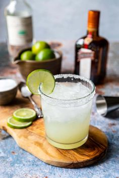 a margarita sitting on top of a wooden cutting board