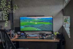 a flat screen tv sitting on top of a wooden desk