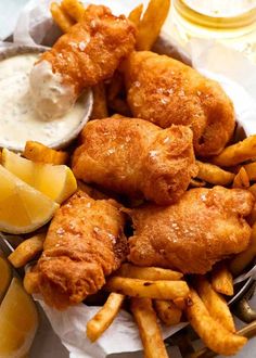 fried fish and fries with dipping sauce on the side