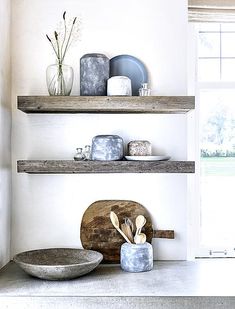 two wooden shelves with plates and bowls on them