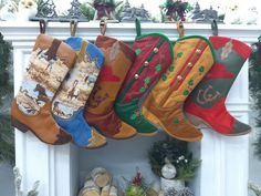 christmas stockings hanging from hooks in front of a fireplace