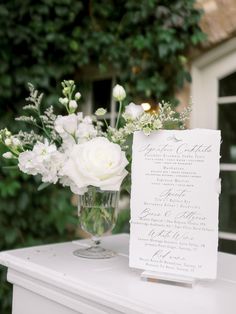 a table with a menu and flowers on it