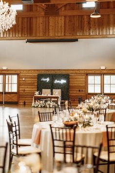 a large room with tables and chairs set up for a formal function at the lodge