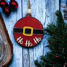 a christmas ornament hanging from a tree on top of a blue wooden table