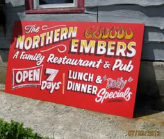 a red sign advertising the northern embers restaurant and pub in front of a building