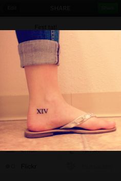 a person with a small roman numeral tattoo on their foot