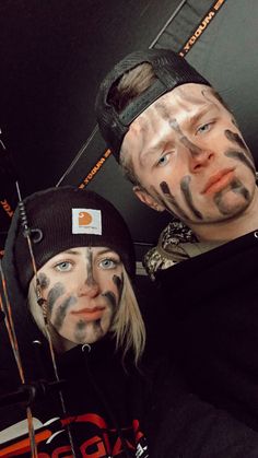 two people with face paint on their faces