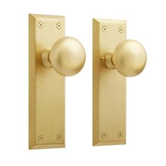 two golden door knobs on an isolated white background