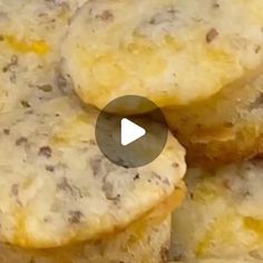 some biscuits are stacked on top of each other with cheese and meat in the middle