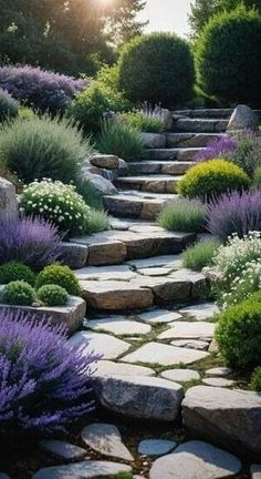 a stone path surrounded by purple flowers and greenery with the sun in the background