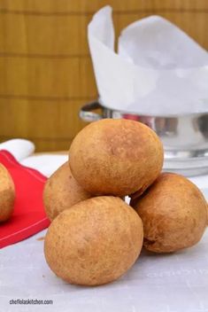 some food that is sitting on top of a white table with napkins in the background