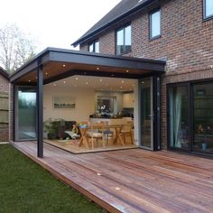 an outdoor patio with wooden decking and sliding glass doors