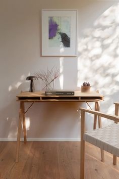 a wooden table sitting next to a white chair