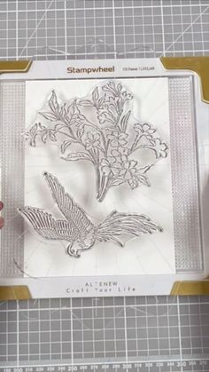 someone is cutting out some flowers in the shape of a bird on a piece of paper