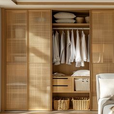 an open closet with clothes and baskets on the floor, in front of a bed