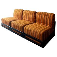 an orange striped couch sitting on top of a wooden frame